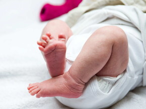 Baby leg and bottom in diaper Baby leg and bottom in diaper