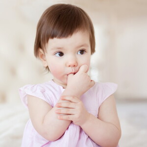 Baby girl sucking thumb
