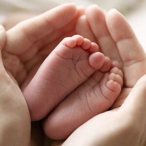 Baby feet in mother hand