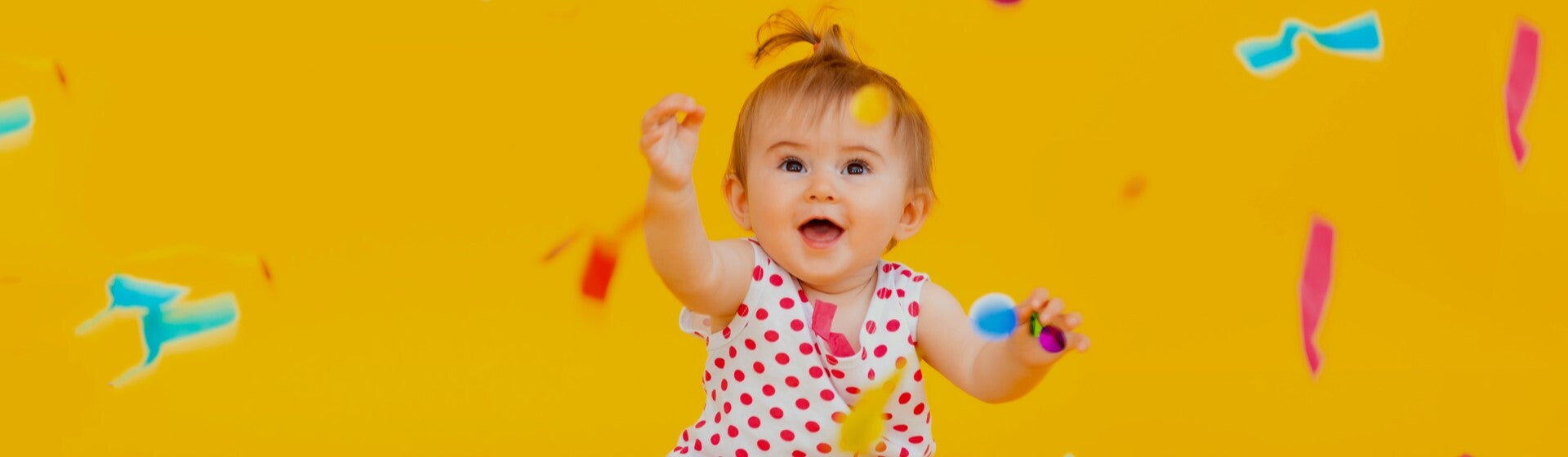 Child playing with confetti_1920x560.jpg